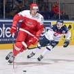 MINSK, BELARUS - MAY 20: Denmark's Oliver Lauridsen #25 stickhandles the puck with  Slovakia's Martin Reway #77 chasing during preliminary round action at the 2014 IIHF Ice Hockey World Championship. (Photo by Richard Wolowicz/HHOF-IIHF Images)